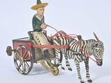 a figurine of a man riding in a horse drawn carriage with a zebra