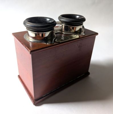 une petite boîte en bois munie de deux boutons métalliques
