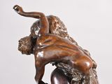 bronze statue of a man wrestling a woman on a marble base