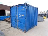 a blue shipping container sitting in the middle of a lot