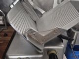 an image of a commercial meat slicer in a kitchen