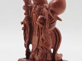 an old chinese carved figurine of a man and a woman