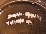 a close up of a vase with writing on it