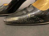 a close up of a pair of black shoes on a table
