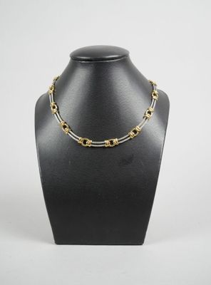 a black mannequin with a gold chain on it
