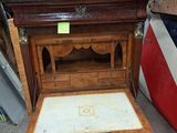 a small wooden table with a drawer on top of it