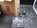 a box and a printer sitting on the floor next to a laptop