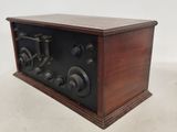 an old fashioned radio sitting on top of a wooden table
