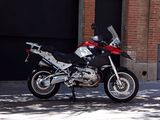 a red and black motorcycle parked in front of a building
