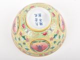 a bowl with a floral design on it on a white surface