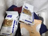 many bags of food sitting in a bin on the floor