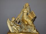 a statue of a woman holding a fan and a child