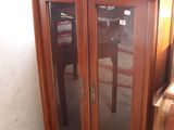 a wooden cabinet with glass doors in a room