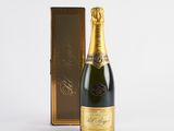 a bottle of champagne in front of a wooden box