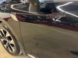 a close up of a car door with a sticker on it