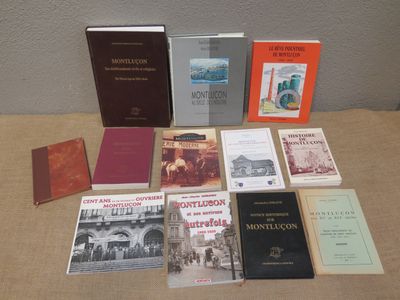 several books are sitting on a table in front of a wall