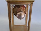a gold clock that is sitting on a table