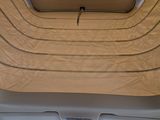 a view of a car ' s sunroof from inside of the vehicle