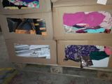 two boxes of clothes on a pallet in a warehouse