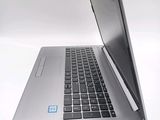 a silver laptop computer sitting on top of a white table