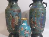 three vases sitting next to each other on a white surface