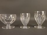 three glass goblets sitting on top of a table next to each other