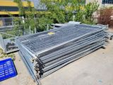 a pile of steel bars on the ground next to a blue crate