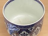 a blue and white bowl sitting on a wooden table