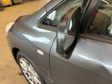 a close up of a car ' s side mirror and door handle