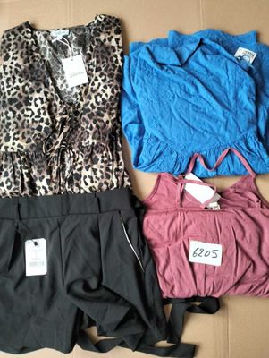 three pieces of clothing are laid out on a cardboard box