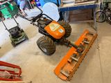 a man that is working on a lawn mower in the garage