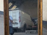 a reflection of a van in a mirror on the ground