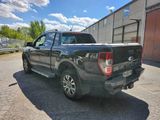 a black pickup truck parked in front of a building