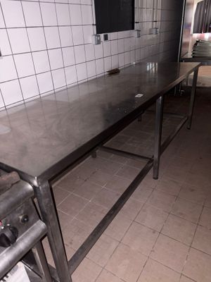a kitchen with a table and a stove in it