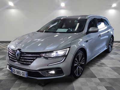 a silver car parked in a room with a checkered floor