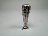 a silver vase that is sitting on a table
