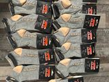 several pairs of men ' s socks are stacked on top of each other