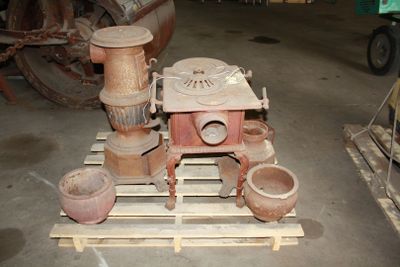 several pots and pans are sitting on a pallet in a warehouse