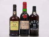trois bouteilles de vin posées les unes à côté des autres sur une surface blanche
