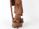 statue of a man with a staff and a hat on a white background