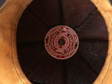 a brown hat with a fire department emblem on it
