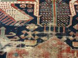 a close up of a rug with a cat on it ' s back