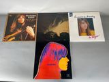 a group of four lp ' s on a table with a woman ' s face