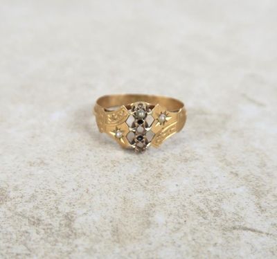 a close up of a gold ring with a stone in the middle