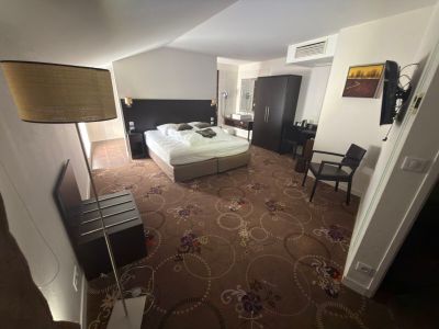 a room with a bed and a desk in it