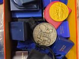 a box full of medals and other items on a table