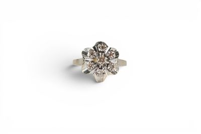 a close up of a diamond ring on a white surface