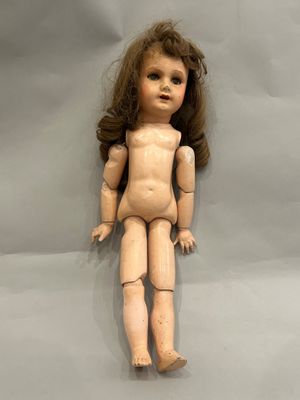 a wooden doll that is sitting on a table