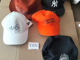 many hats that are sitting on top of a cardboard box