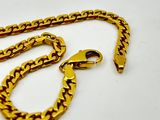 an image of a gold chain on a white surface